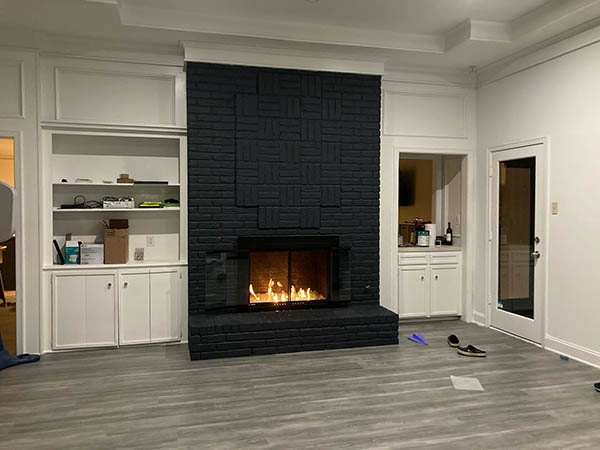 Black brick fireplace with fire