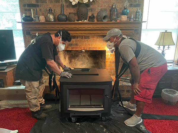 technicians wearing masks install fireplace
