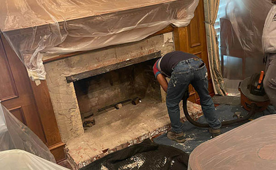Fireplace Contractors cleaning fireplace